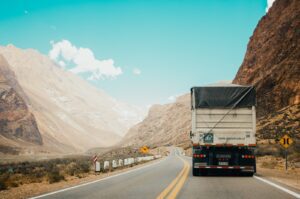 white and black truck near mountain at daytime